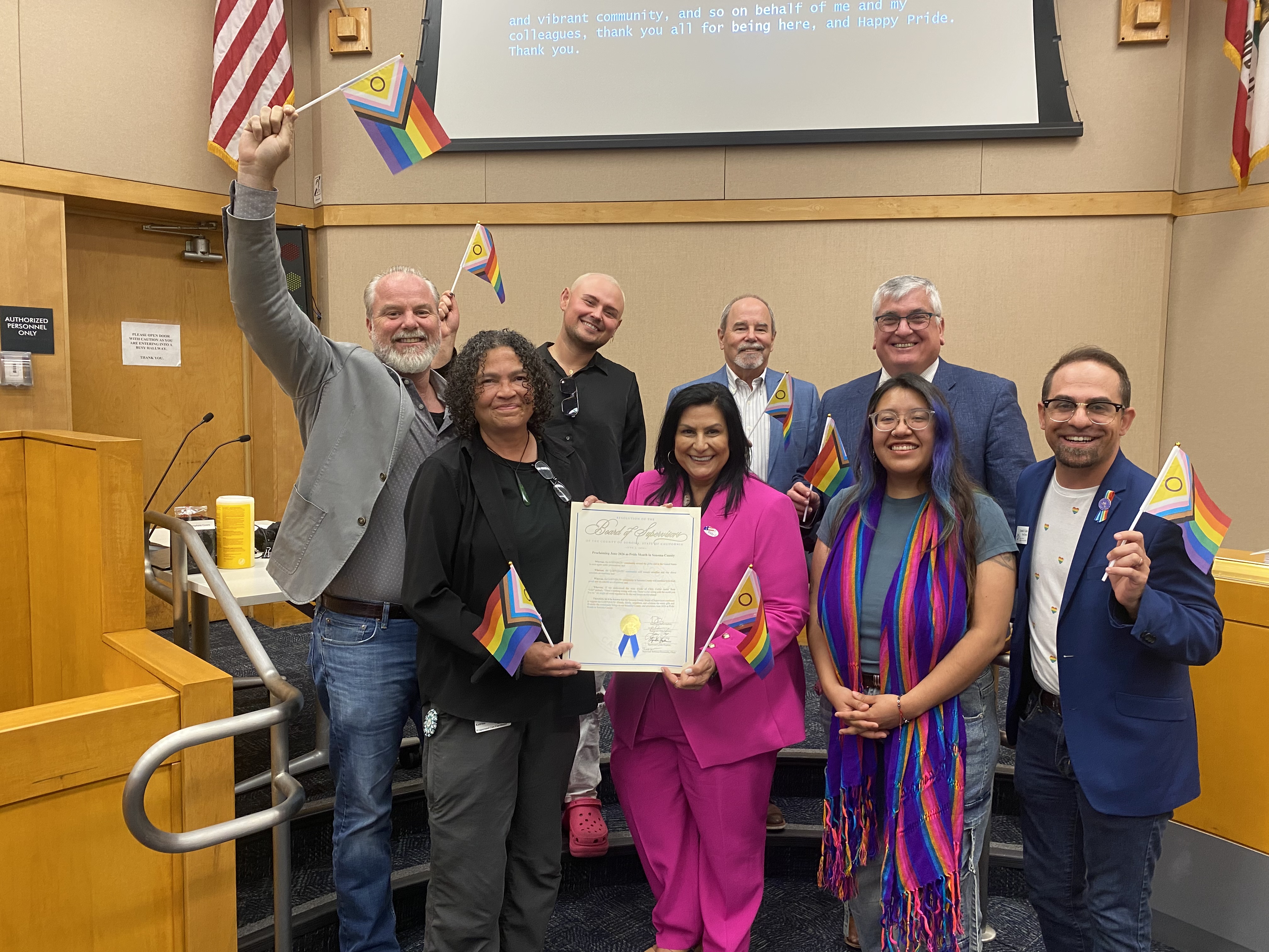 The Commission on Human Rights accepting a resolution from the Board of Supervisors
