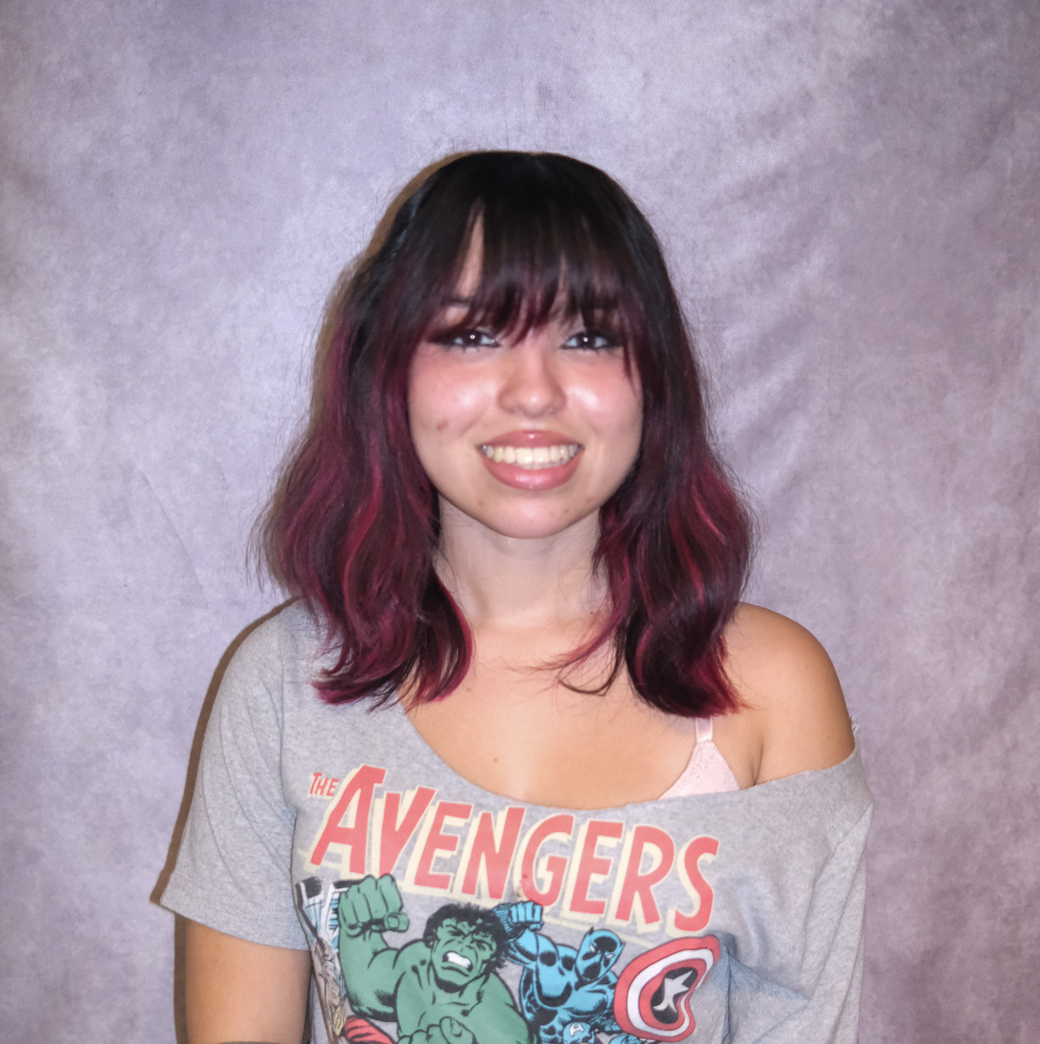 Briana posing in front of a gray background