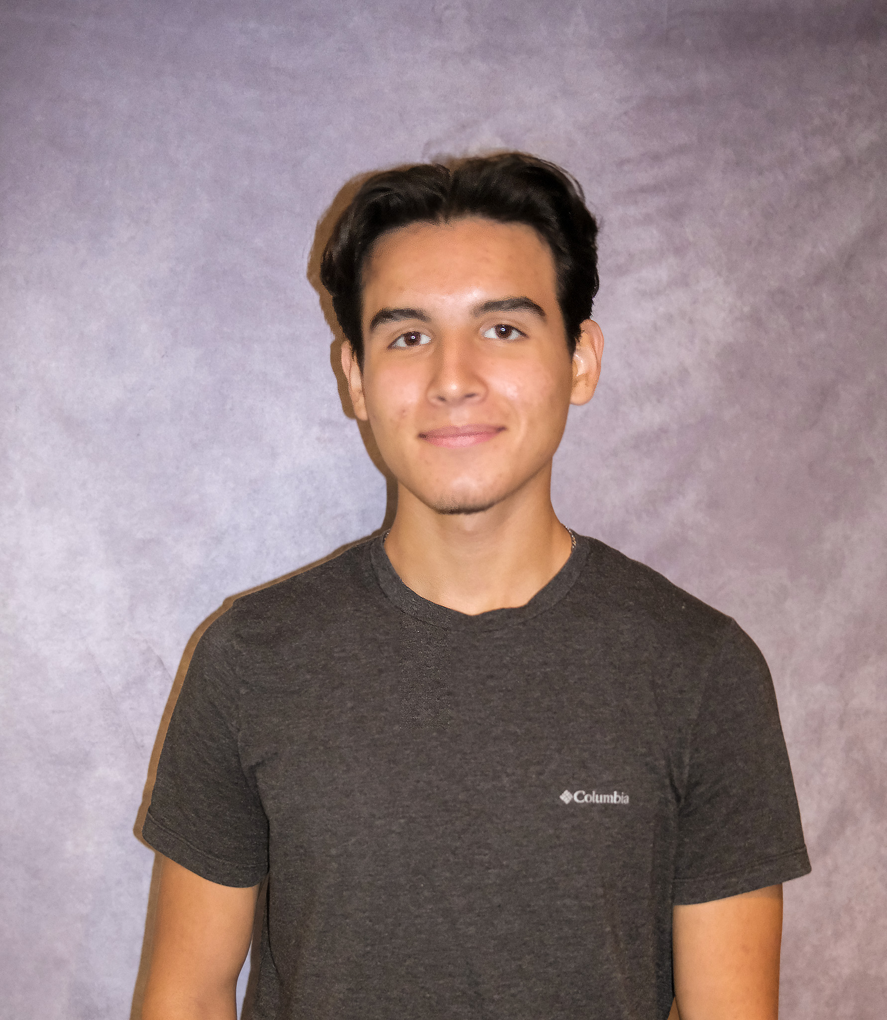 Gerry standing in front of a gray background