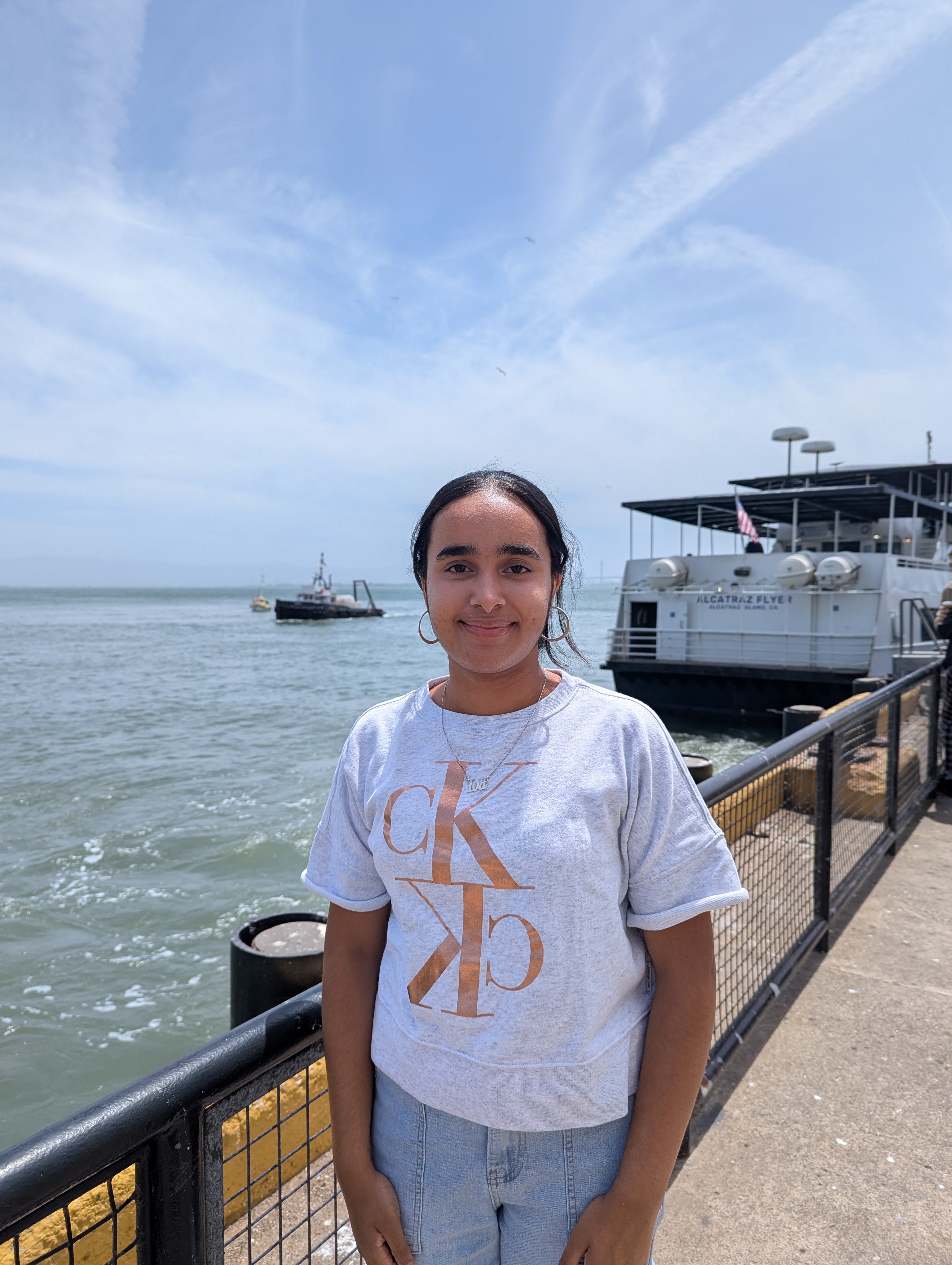 Iva in the pier with a boat in the background