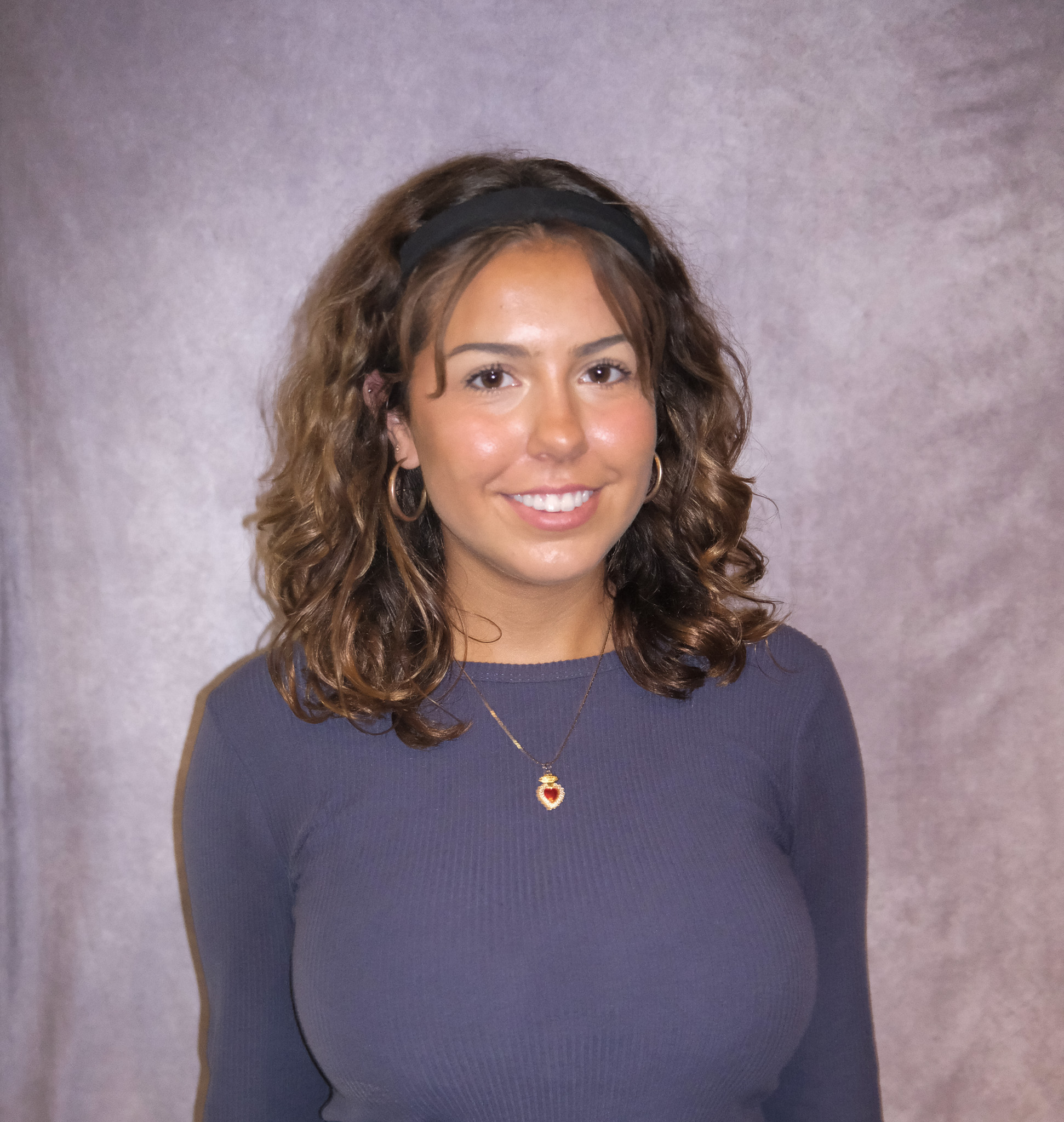 Leigha posing in front of a gray background