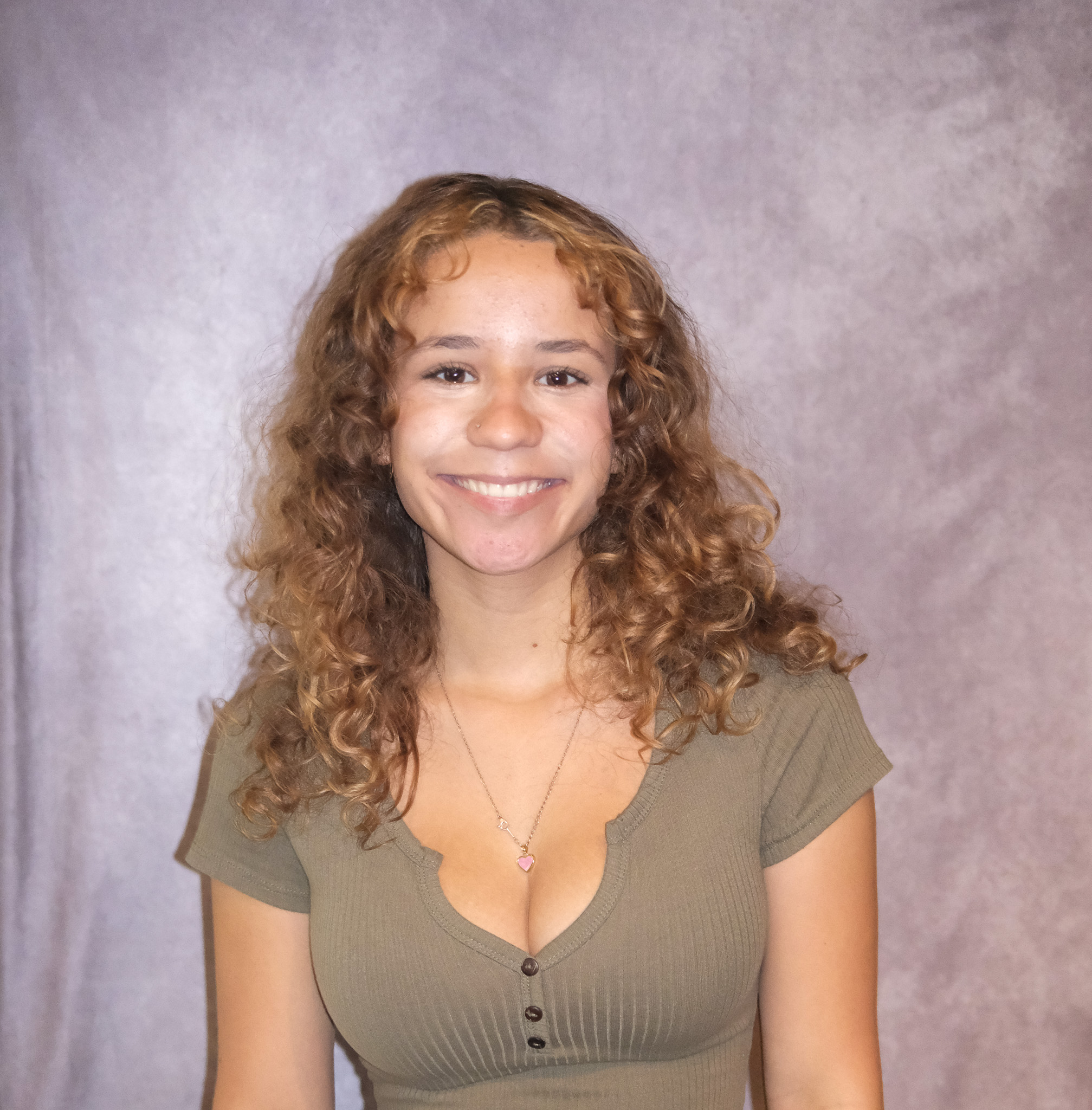 Marianna posing in front of a gray background