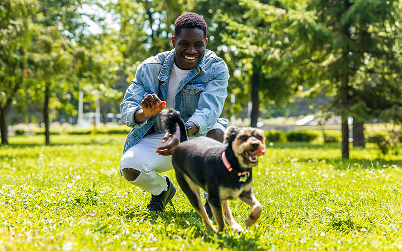 Man with dog on a leash outside